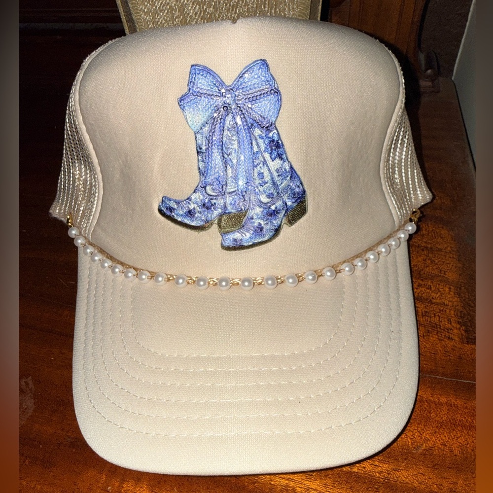New. Never worn. Beige hat with Blue Sequin Boot Design and Pearl Detail